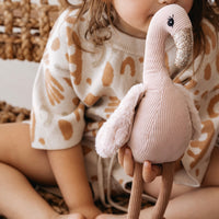 Vera Flamingo soft toy on a nursery shelf