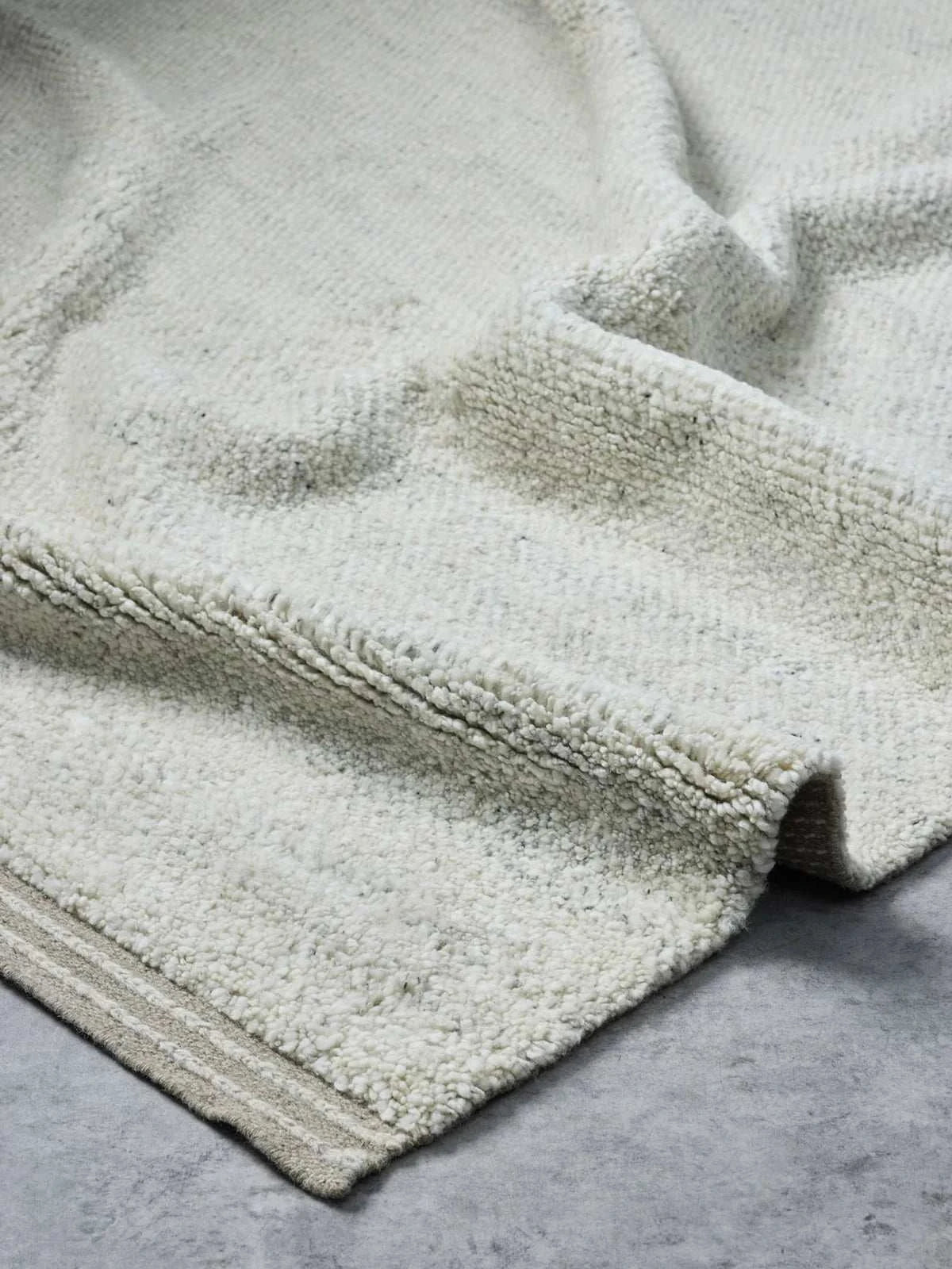 Handloomed Vogel Rug in fawn with soft wool pile and linear border design