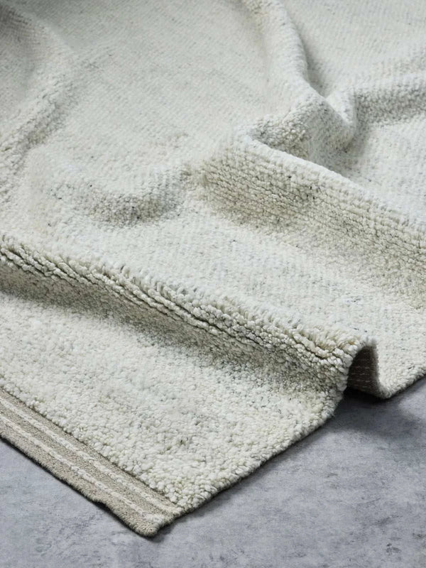 Handloomed Vogel Rug in fawn with soft wool pile and linear border design