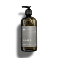 Works Body Soap Salt Bush in 500ml smoky grey glass bottle with pump dispenser, featuring natural plant-based ingredients and earthy coastal scent.