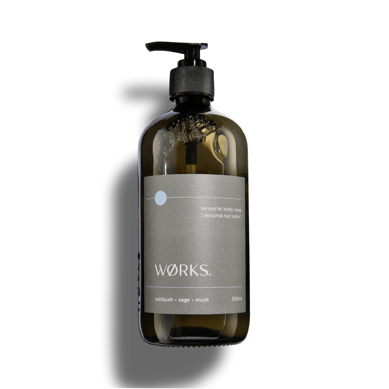 Works Body Soap Salt Bush in 500ml smoky grey glass bottle with pump dispenser, featuring natural plant-based ingredients and earthy coastal scent.
