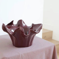 norsu Studio Flow sculptural ceramic bowl in burgundy with ruffled edges and glossy finish