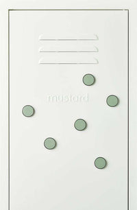 Set of six sage green Mustard Made The Buttons magnets with smooth flat surface on a white magnetic board