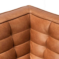 Close-up corner view of Ethnicraft Sofa N701 in Old Saddle aniline leather upholstery showing detailed stitching and plush cushioning