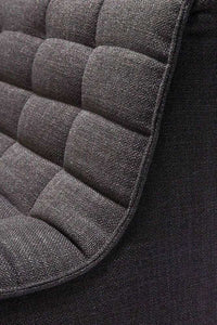 Close-up of dark grey fabric upholstery on Ethnicraft Sofa N701 one-seater showing textured padded cushion detailing
