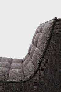 Close-up of dark grey Ethnicraft Sofa N701 1 seater with tufted upholstery and cushioned backrest.