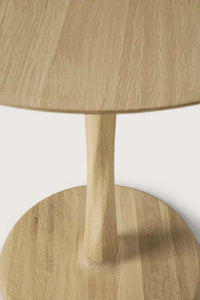 Ethnicraft Oak Torsion dining table with round top and sculptural twisted oak base in natural varnished finish