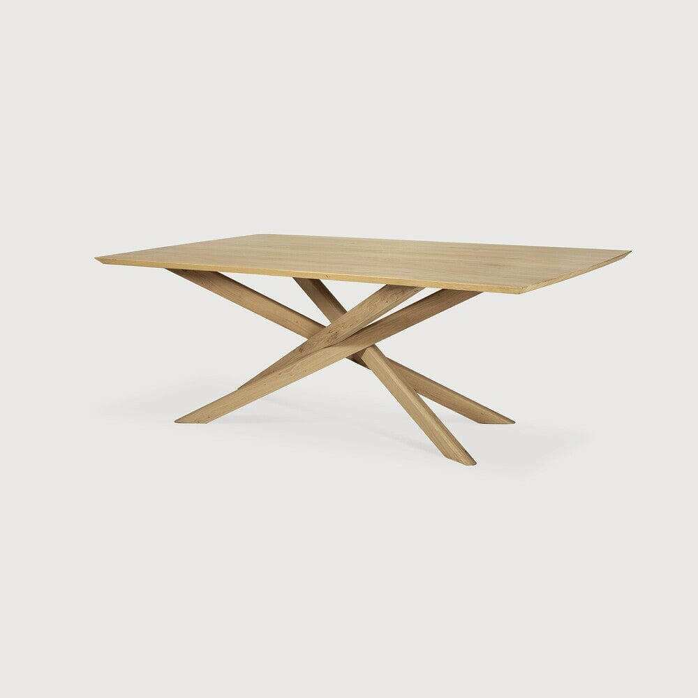 Ethnicraft Mikado dining table in natural oak with sculptural, interlocking legs and solid wood top.