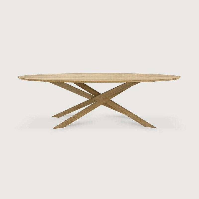 Ethnicraft Mikado Oval Dining Table in natural oak with solid wood crossed legs and elliptical tabletop