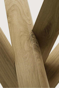 Close-up of Ethnicraft Oak Mikado Side Table's solid oak wood with visible grain and intersecting legs design