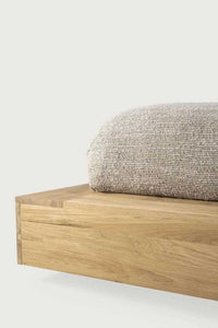 Close-up of Ethnicraft Madra Bed frame in natural oak with linen bedding detail