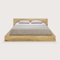 Ethnicraft Madra Bed in natural oak wood with minimalist design and beige bedding