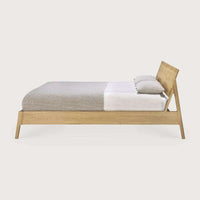 Side view of Ethnicraft Air Bed in natural oak with solid European oak frame and neutral bedding