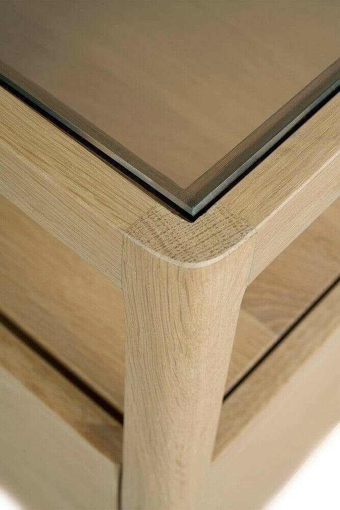 Close-up of Ethnicraft Spindle Bedside Table corner showing natural oak wood grain and smokey glass top