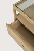 Ethnicraft Spindle Bedside table in natural oak with smokey glass top and single drawer open showing wood grain detail