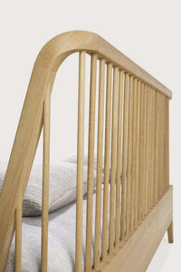 Close-up of Ethnicraft Spindle Bed natural oak headboard with spindle design and tapered legs