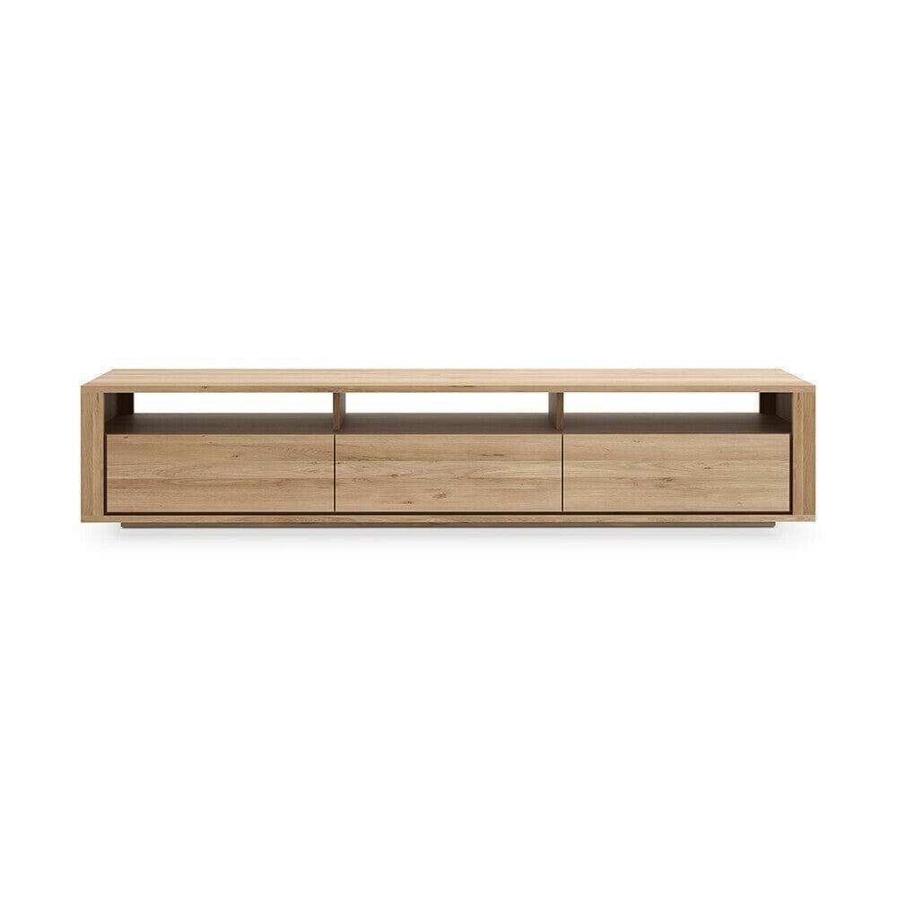 Ethnicraft Shadow TV Stand in natural oak with clean lines, three drawers, and open shelf for media storage.