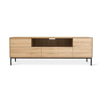 Ethnicraft Whitebird Entertainment Unit in natural oak with one door, one flip-down door, two drawers, and metal legs.