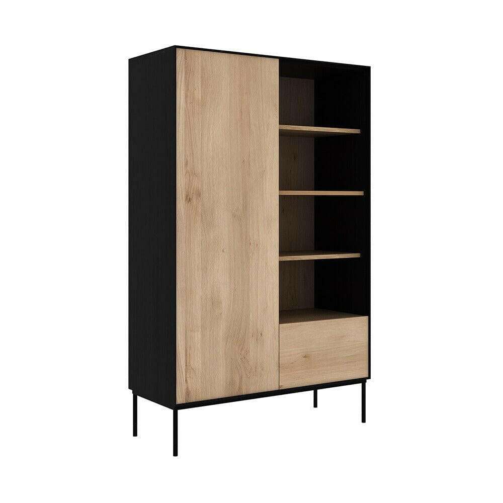 Ethnicraft Blackbird Storage Cupboard with natural oak door, drawer, black frame, and open shelves on metal legs