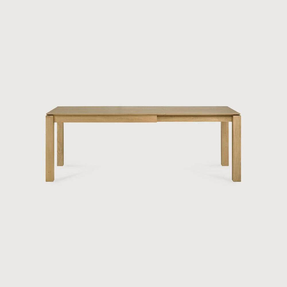 Ethnicraft Slice extendable dining table made of natural oak with clean, minimalist design.
