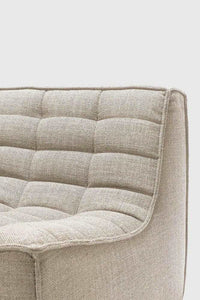 Close-up of Ethnicraft Sofa N701 Corner in dark beige fabric upholstery with a plush, quilted design