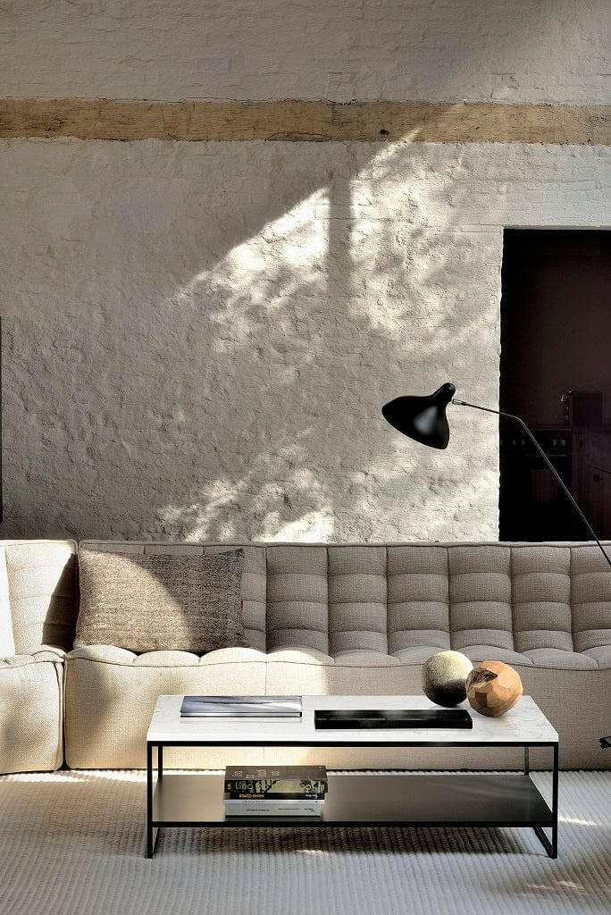 Ethnicraft Sofa N701 three-seater in dark beige with modern design and comfortable cushions in a bright living room setting.