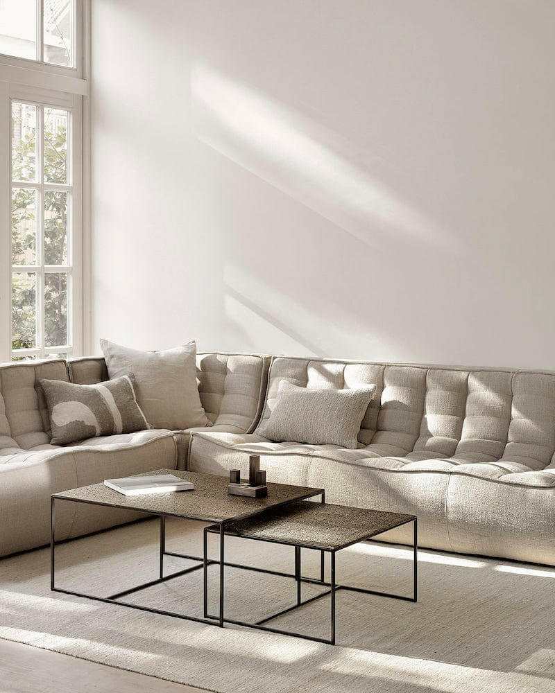 Ethnicraft Sofa N701 three-seater in dark beige with tufted upholstery in a bright living room setting