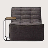 Dark grey Ethnicraft Sofa N701 single-seater with tufted upholstery and attached side table.