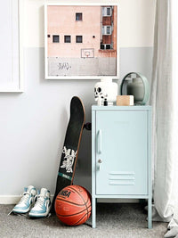 Light blue Mustard Made Locker The Shorty Ocean beside a skateboard, basketball, and sneakers in a modern room