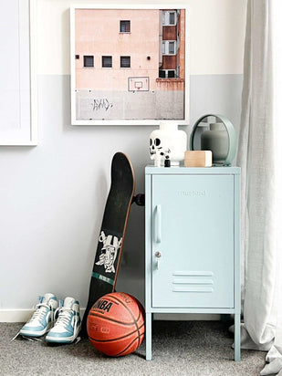 Light blue Mustard Made Locker The Shorty Ocean beside a skateboard, basketball, and sneakers in a modern room