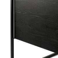 Close-up of black tainted solid oak wood grain and black metal frame of Ethnicraft Oak Monolit sideboard.