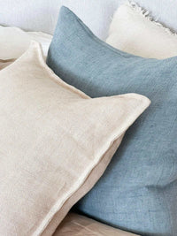 Baya Flaxmill Cushion in nude linen with natural textured weave on sofa