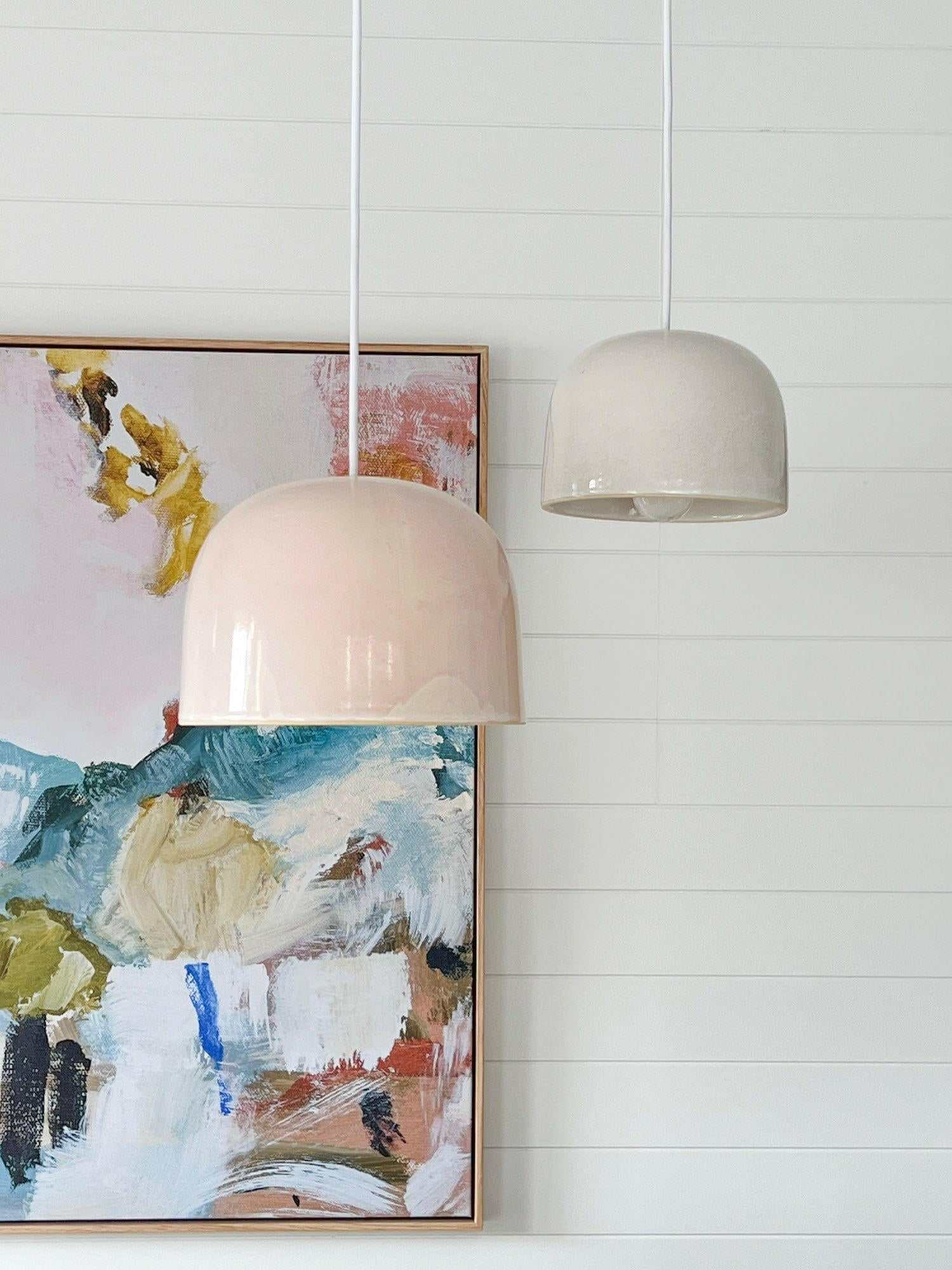 Robert Gordon Bell Light large ceramic dome pendant in cream, hanging with white cord in modern interior setting