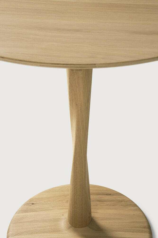 Ethnicraft Oak Torsion dining table with solid oak twisted central base and round top in varnished finish