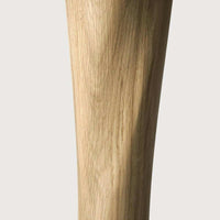 Close-up of Ethnicraft Oak Torsion dining table leg showcasing solid oak wood grain and varnished finish