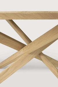 Close-up of Ethnicraft Oak Mikado round coffee table legs in solid oak with a hardwax oil finish.