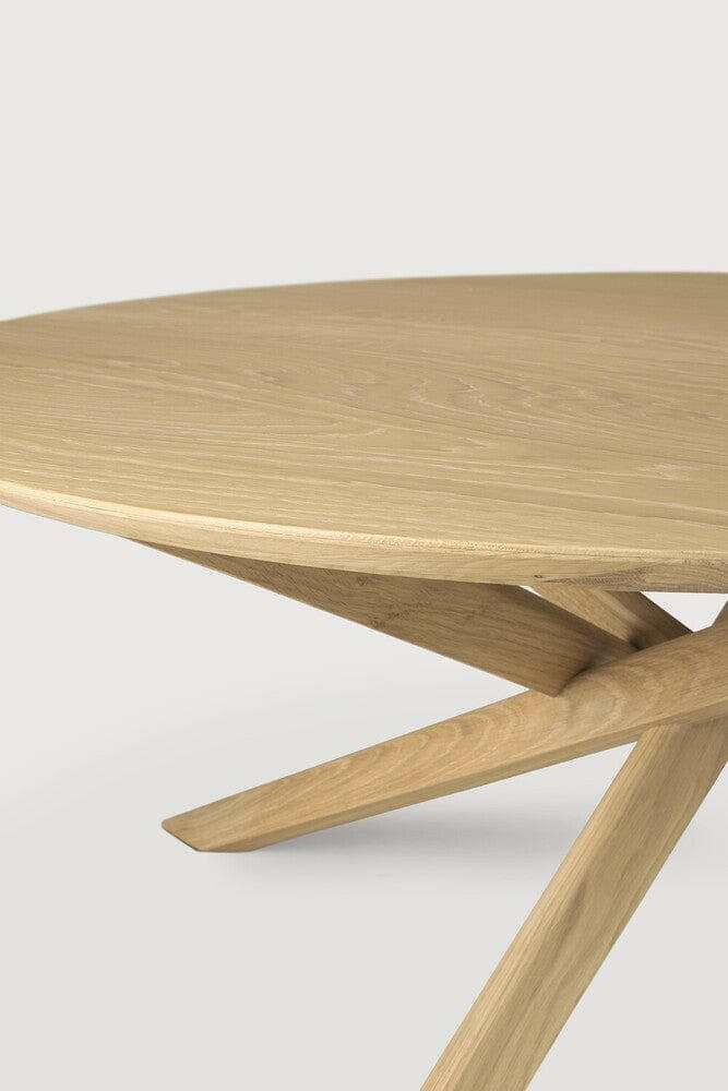 Ethnicraft Oak Mikado round coffee table with solid oak top and crossed leg design in natural finish