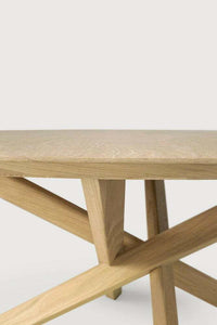 Close-up of Ethnicraft Oak Mikado round coffee table with solid oak crossed legs and a hardwax oil finish