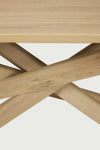 Close-up of the solid European Oak natural finish Ethnicraft Dining Table Mikado showing the inward flowing interlocking legs design.