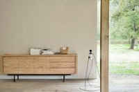 Ethnicraft Oak Shadow Sideboard in natural oak with 3 doors and drawers, sleek modern design in a bright room with a natural outdoor view