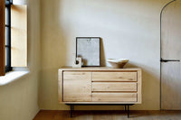 Ethnicraft Oak Shadow Sideboard in natural oak with one door and three drawers, minimal design in a modern room setting