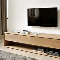 Ethnicraft Nordic Entertainment Unit in natural oak with minimalist design and storage drawers under wall-mounted TV