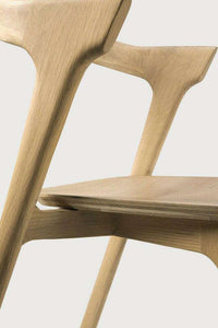 Close-up of Ethnicraft Bok Dining Chair in natural solid oak with sculptural backrest and seat design