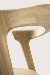 Close-up of Ethnicraft Bok Dining Chair made from natural oak wood showing its sculptural and elegant design.