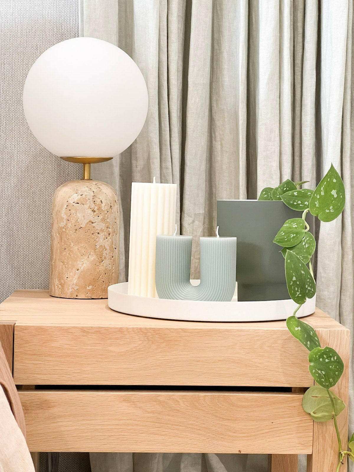 Black Blaze candles Curl Curl sculptural unscented plant-based wax candles on wooden table with lamp and green plant