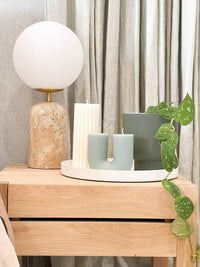 Black Blaze candles Curl Curl sculptural unscented plant-based wax candles on wooden table with lamp and green plant