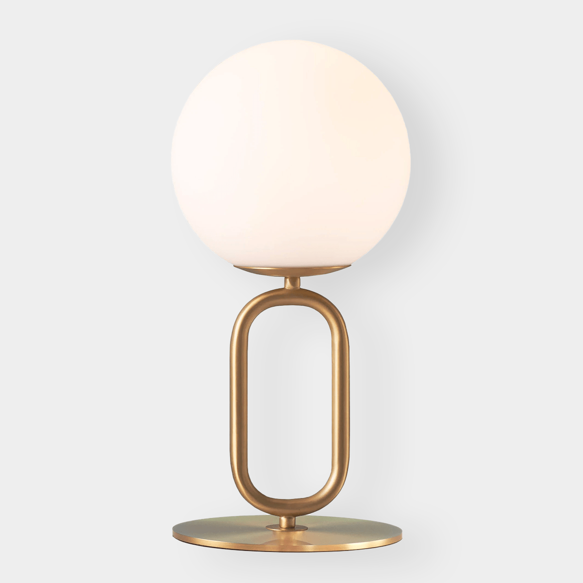 Modern brass desk lamp with frosted glass shade and oval base, elegant ambient lighting for workspace or living room.