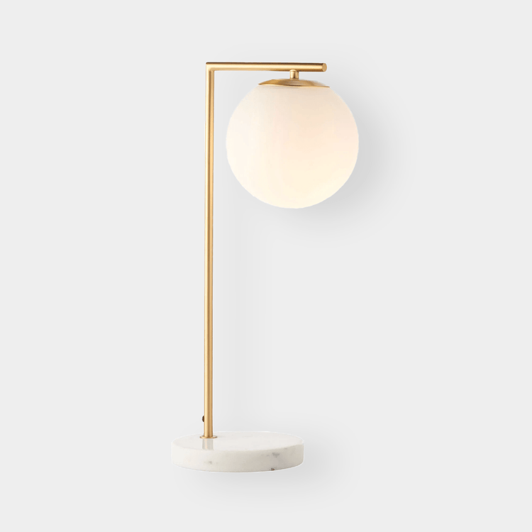 Remi Desk Lamp with antique brass finish, white marble base, and frosted glass shade in mid-century modern style