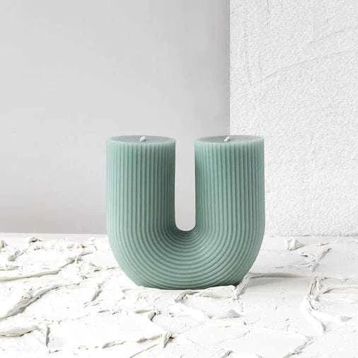 Black Blaze Curl Curl Sage candle with sculptural U-shape and ribbed texture, made from plant-based wax, unscented and decorative.