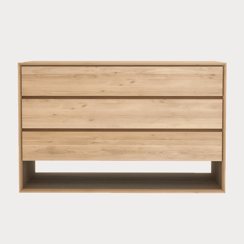 Ethnicraft Nordic 3 drawer chest of drawers in natural oak wood with open base storage.